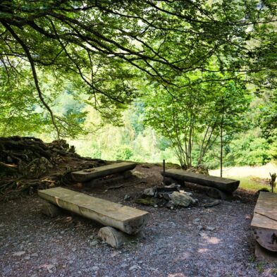 Winding road over Furka Pass with dramatic views of the Swiss Alps and distant glaciers