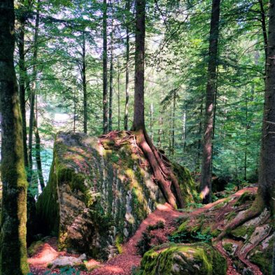 Winding road over Furka Pass with dramatic views of the Swiss Alps and distant glaciers