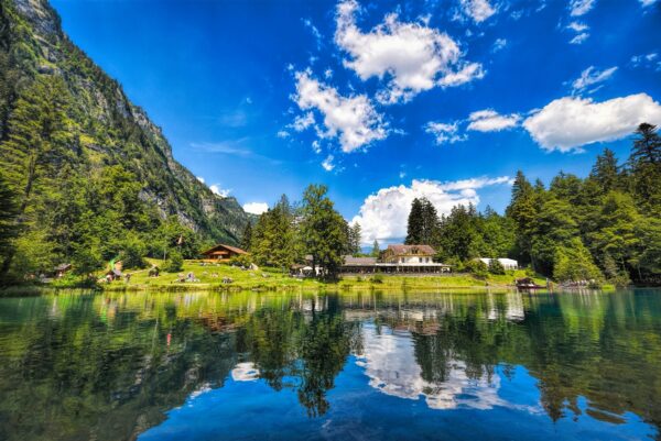Winding road over Furka Pass with dramatic views of the Swiss Alps and distant glaciers