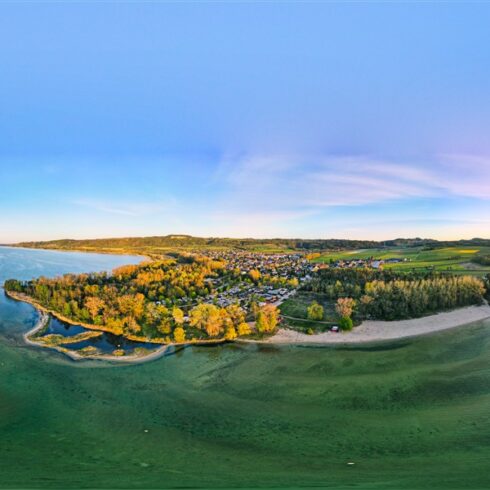 Sandy beach and calm turquoise water at Plage d’Yvonand