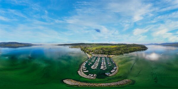 Sandy beach and calm turquoise water at Plage d’Yvonand