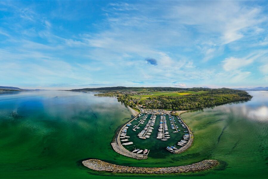 Sandy beach and calm turquoise water at Plage d’Yvonand