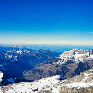 Historic Bellinzona Castle perched on a hilltop, surrounded by lush green landscape