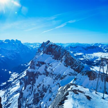 Historic Bellinzona Castle perched on a hilltop, surrounded by lush green landscape