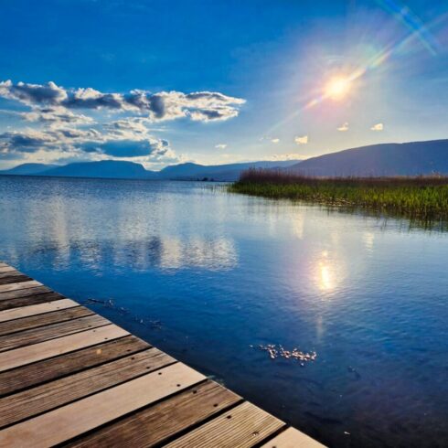 Sunrise casting warm golden light over the towering peaks of the Swiss Alps