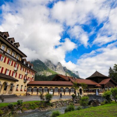 Rolling hills of Mendrisio dotted with traditional Swiss farmhouses and grazing sheep
