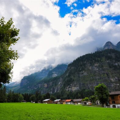 Rolling hills of Mendrisio dotted with traditional Swiss farmhouses and grazing sheep