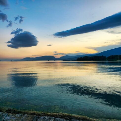 Snow-covered Swiss Alps under a bright blue sky with dramatic cloud formations