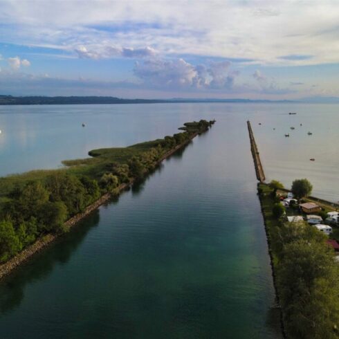 Crystal-clear alpine lake surrounded by towering mountain peaks and lush forests