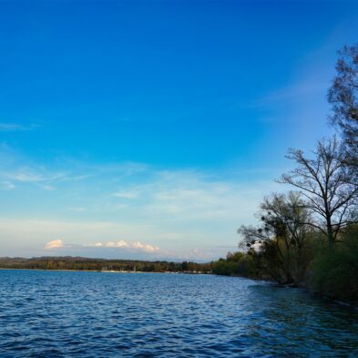 Aerial view of Lugano with its sparkling lake and the surrounding lush mountains