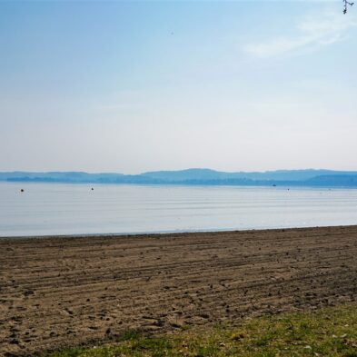 Aerial view of Lugano with its sparkling lake and the surrounding lush mountains