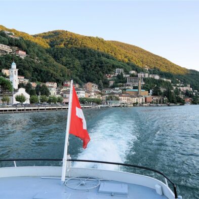Aerial view of Lugano with its sparkling lake and the surrounding lush mountains