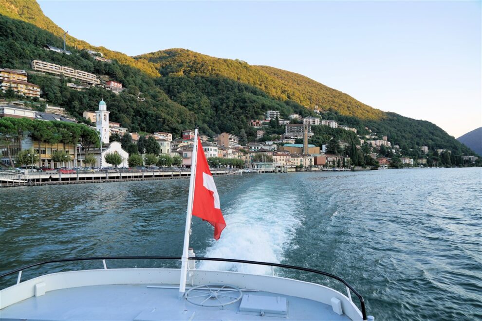 Aerial view of Lugano with its sparkling lake and the surrounding lush mountains