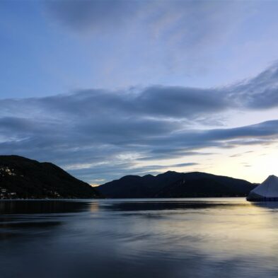 Aerial view of Lugano with its sparkling lake and the surrounding lush mountains