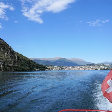 Aerial view of Lugano with its sparkling lake and the surrounding lush mountains
