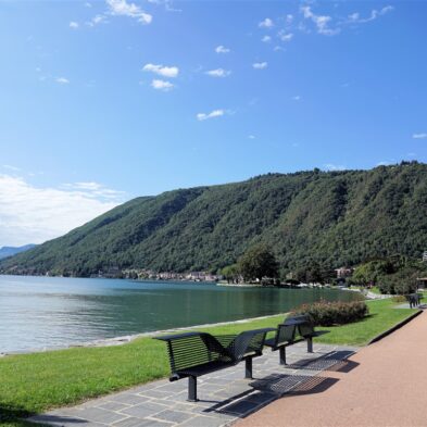 Aerial view of Lugano with its sparkling lake and the surrounding lush mountains