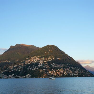 Aerial view of Lugano with its sparkling lake and the surrounding lush mountains