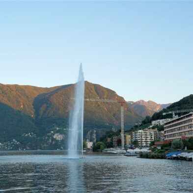 Aerial view of Lugano with its sparkling lake and the surrounding lush mountains