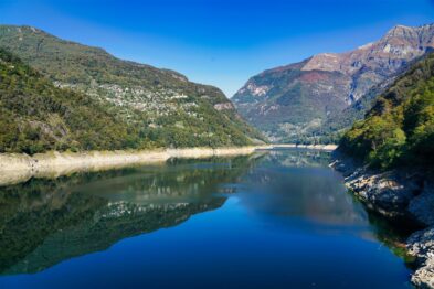 Alpine meadows dotted with wildflowers, nestled between rugged mountain peaks near Furka