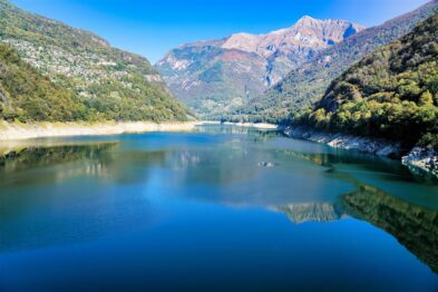 Alpine meadows dotted with wildflowers, nestled between rugged mountain peaks near Furka