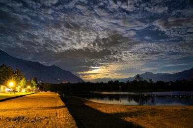 Alpine meadows dotted with wildflowers, nestled between rugged mountain peaks near Furka