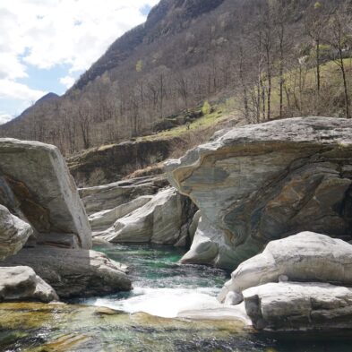 Crystal-clear alpine lake surrounded by towering mountain peaks and lush forests