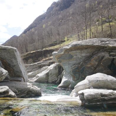 Crystal-clear alpine lake surrounded by towering mountain peaks and lush forests
