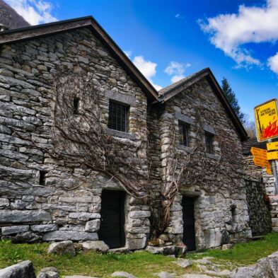 Crystal-clear alpine lake surrounded by towering mountain peaks and lush forests