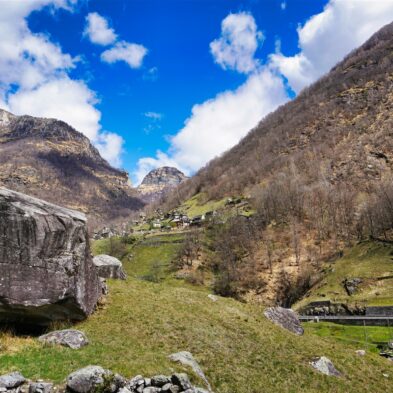 Crystal-clear alpine lake surrounded by towering mountain peaks and lush forests