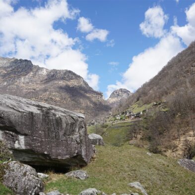 Crystal-clear alpine lake surrounded by towering mountain peaks and lush forests
